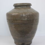 Ancient vase in khaki grey-green cracked sandstone