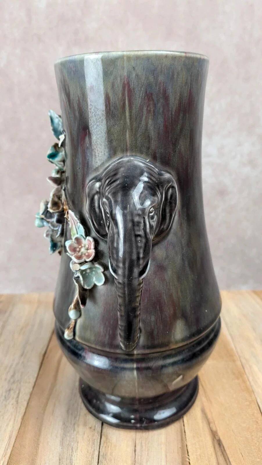 Antique vase in slipware with elephant and flower decoration.