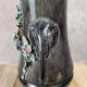 Antique vase in slipware with elephant and flower decoration.