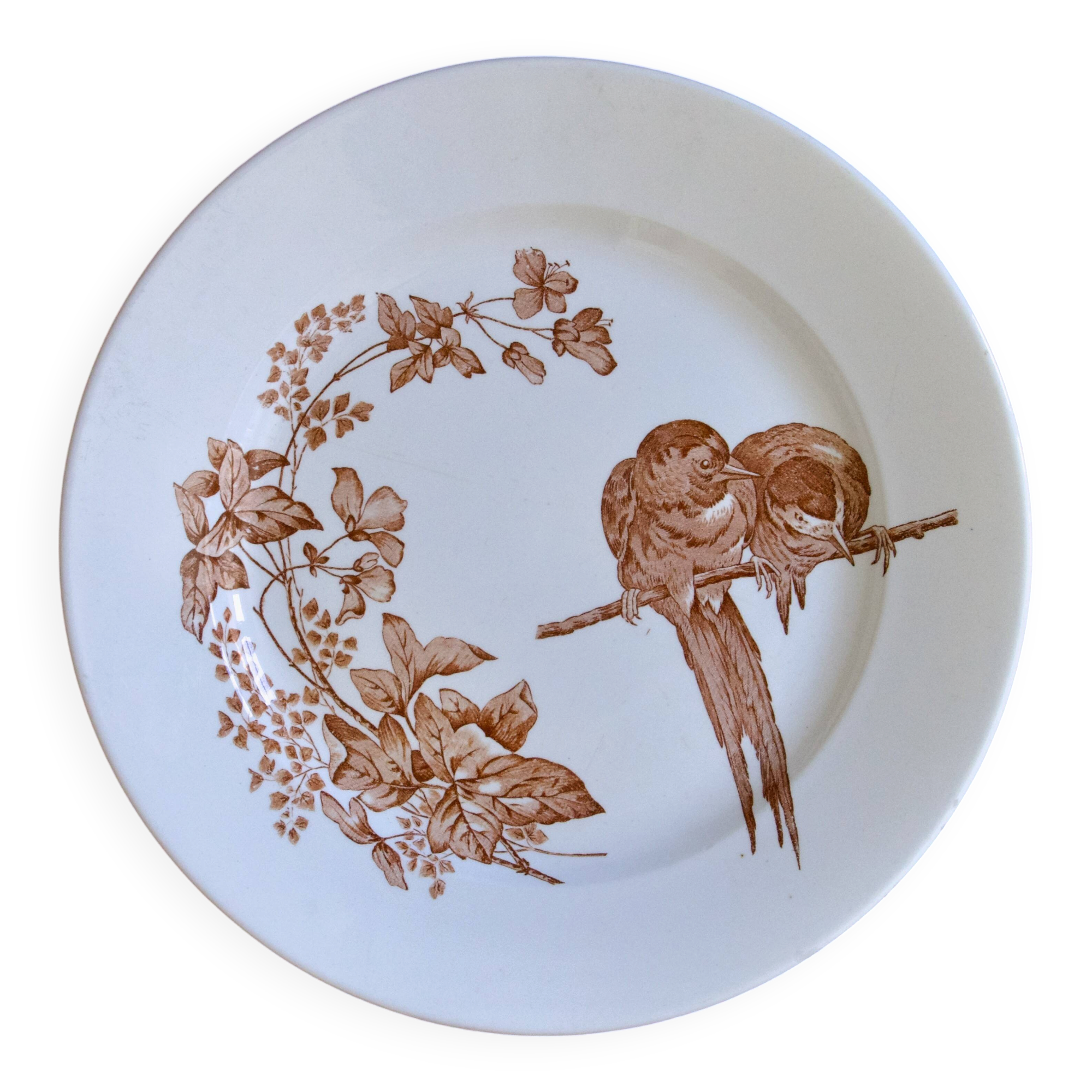 Large round dish from around 1870 signed Longwy with birds in sepia ironstone.