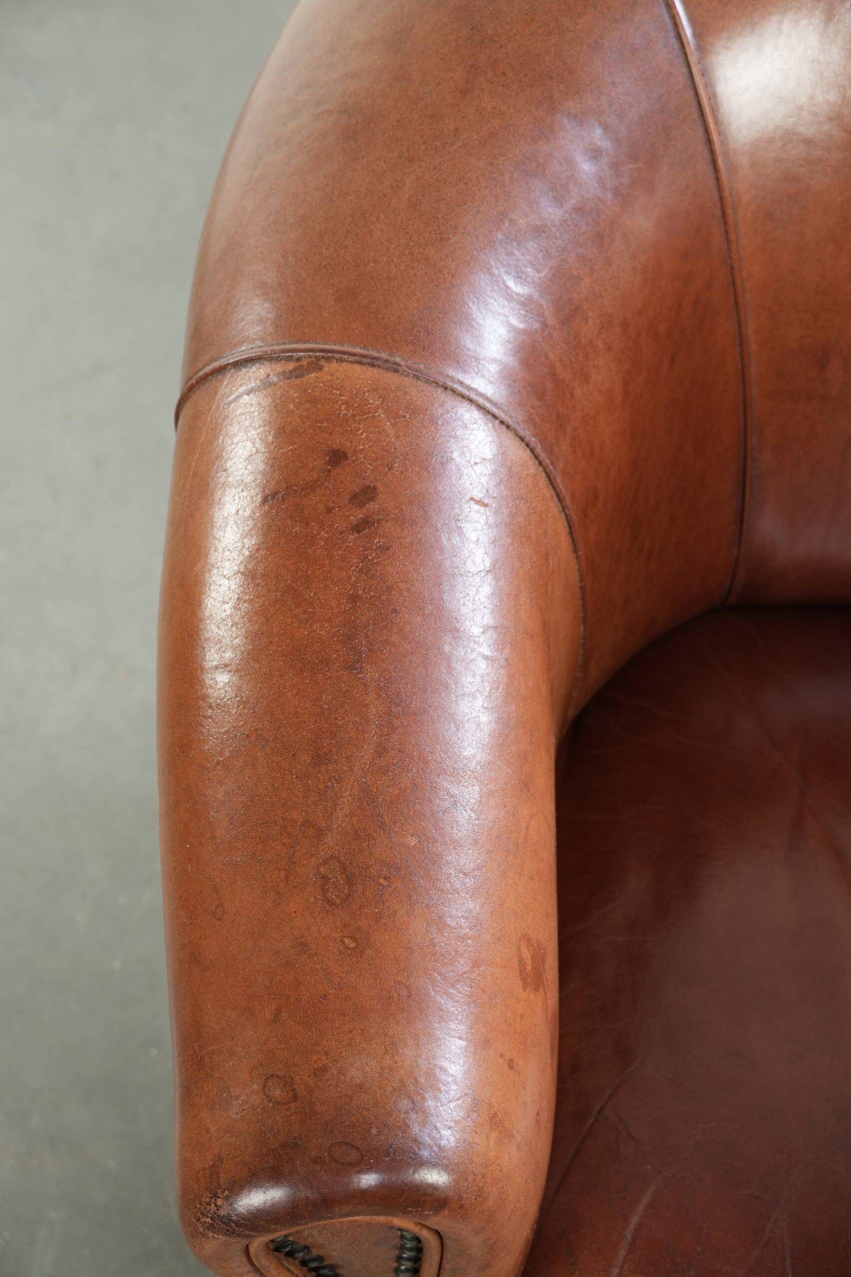 Vintage sheepskin club armchair in English style with deep colours