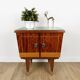1950s bedside table in varnished wood veneer and brass.