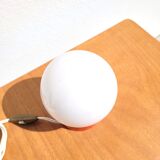 Small vintage opaline ball lamp with an orange base.