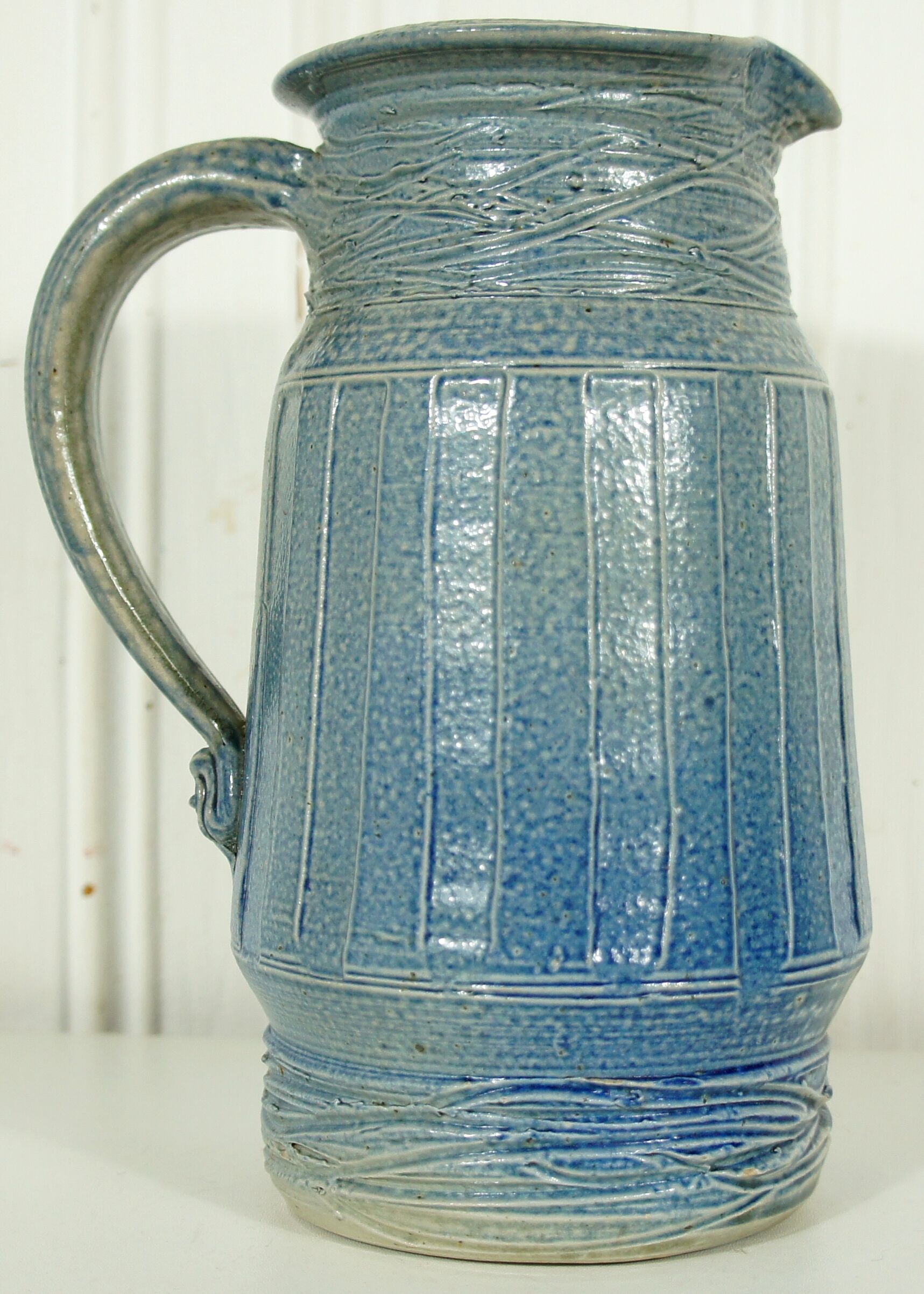 Pitcher in glazed blue sandstone signed