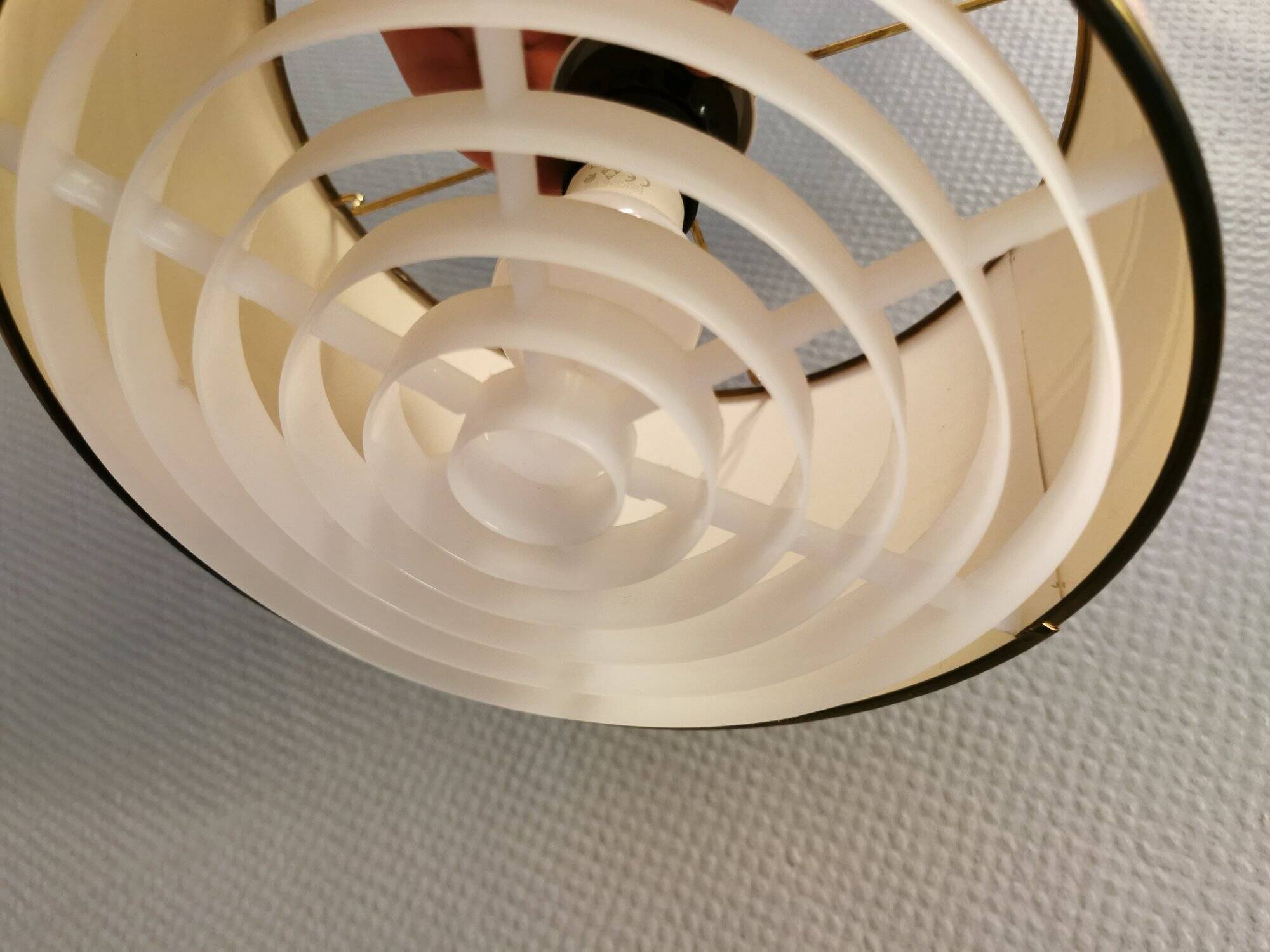 Hanging lamp with brass-coloured details, made of fabric with intact plastic bottom grille.