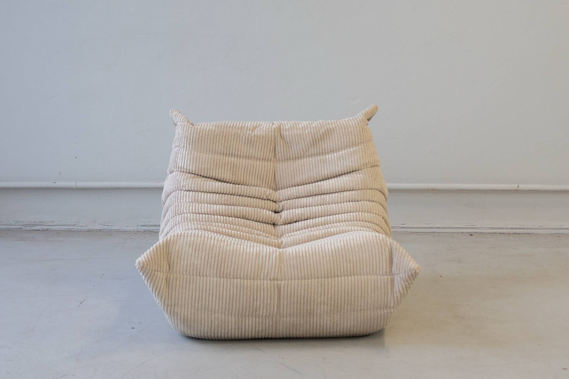Togo set of 2 armchairs and poufne in beige corduroy