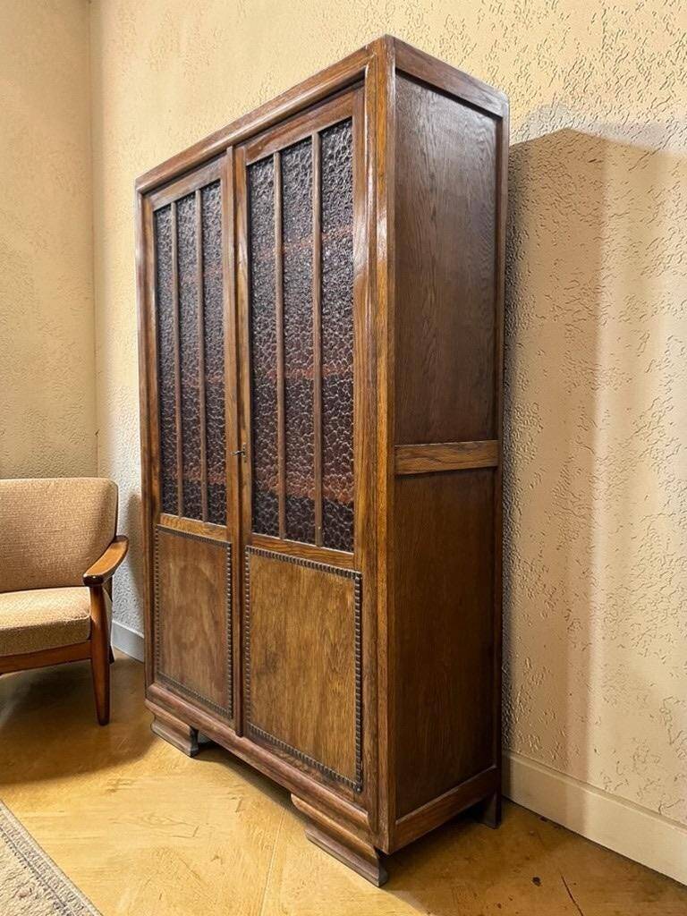 Vintage wooden display cabinet with textured glass.
