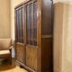 Vintage wooden display cabinet with textured glass.