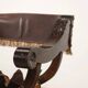 Antique neo-Renaissance folding chair in walnut and leather, Italy, 20th century.