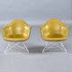 Paire de chaises coque LAR Eames pour Herman Miller avec des coussins en Naugahyde jaune.