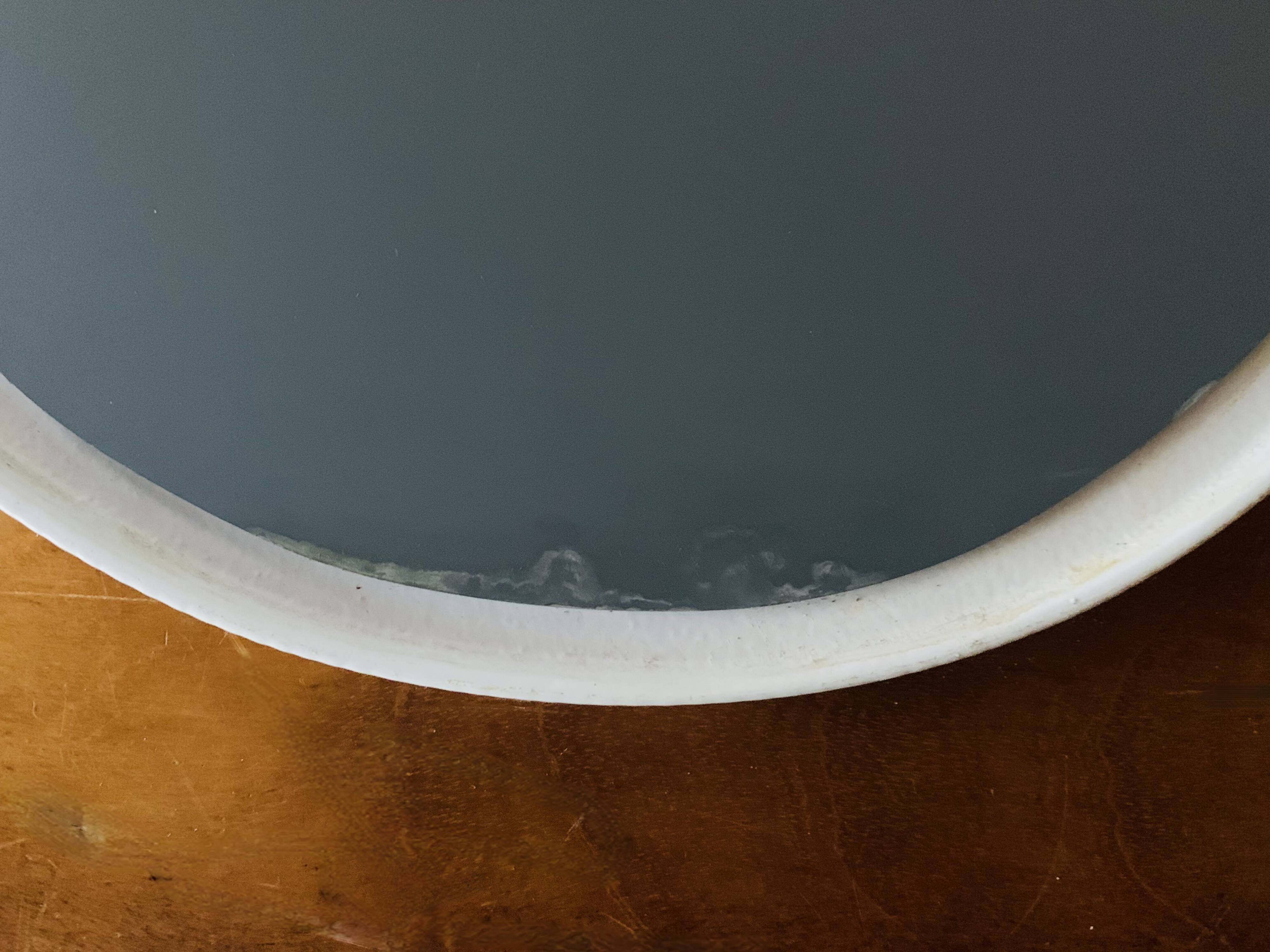 Oval mirror in vintage enameled white cast iron