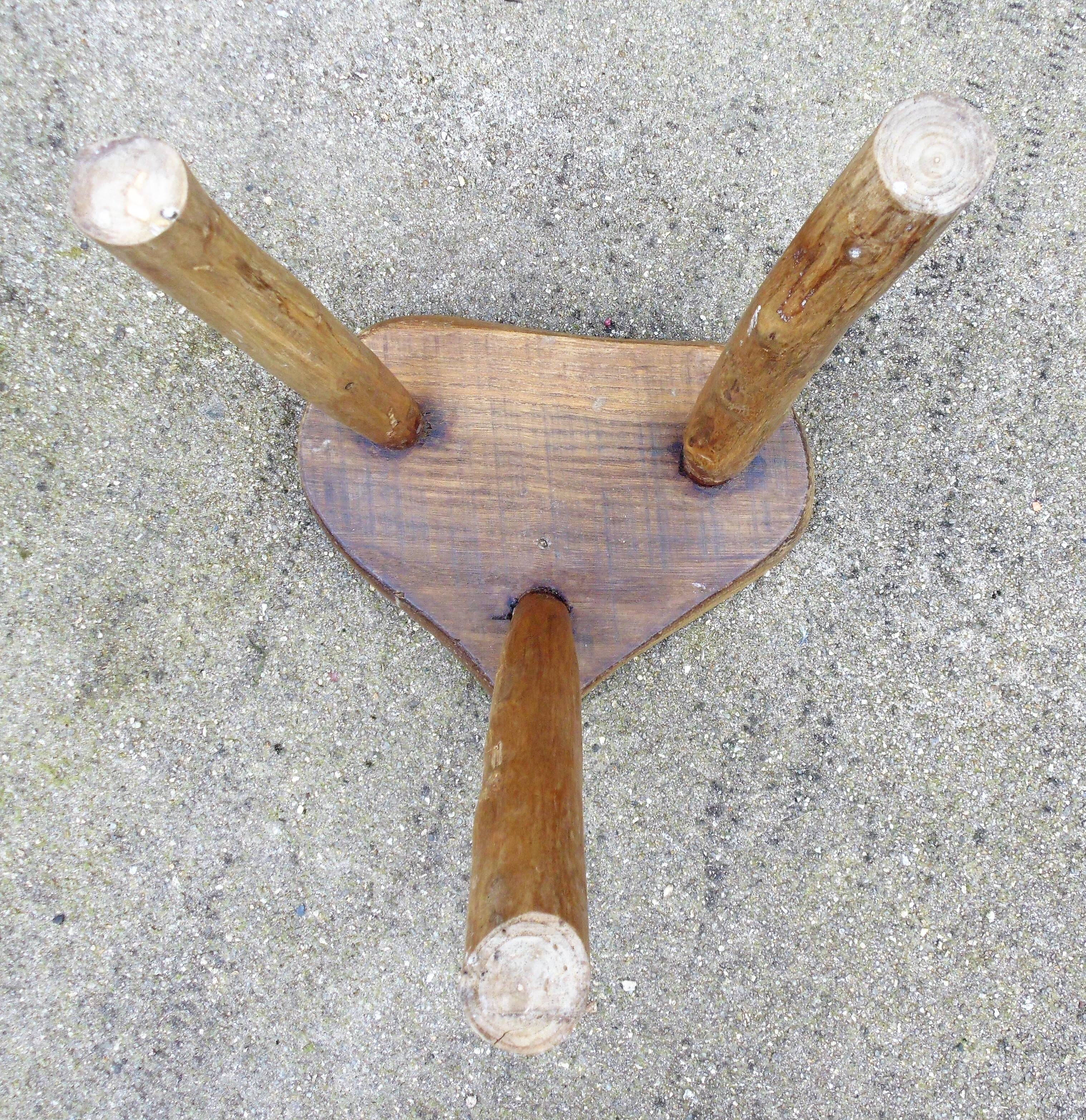 Farm stool in raw wooden sitting in the shape of a popular art
