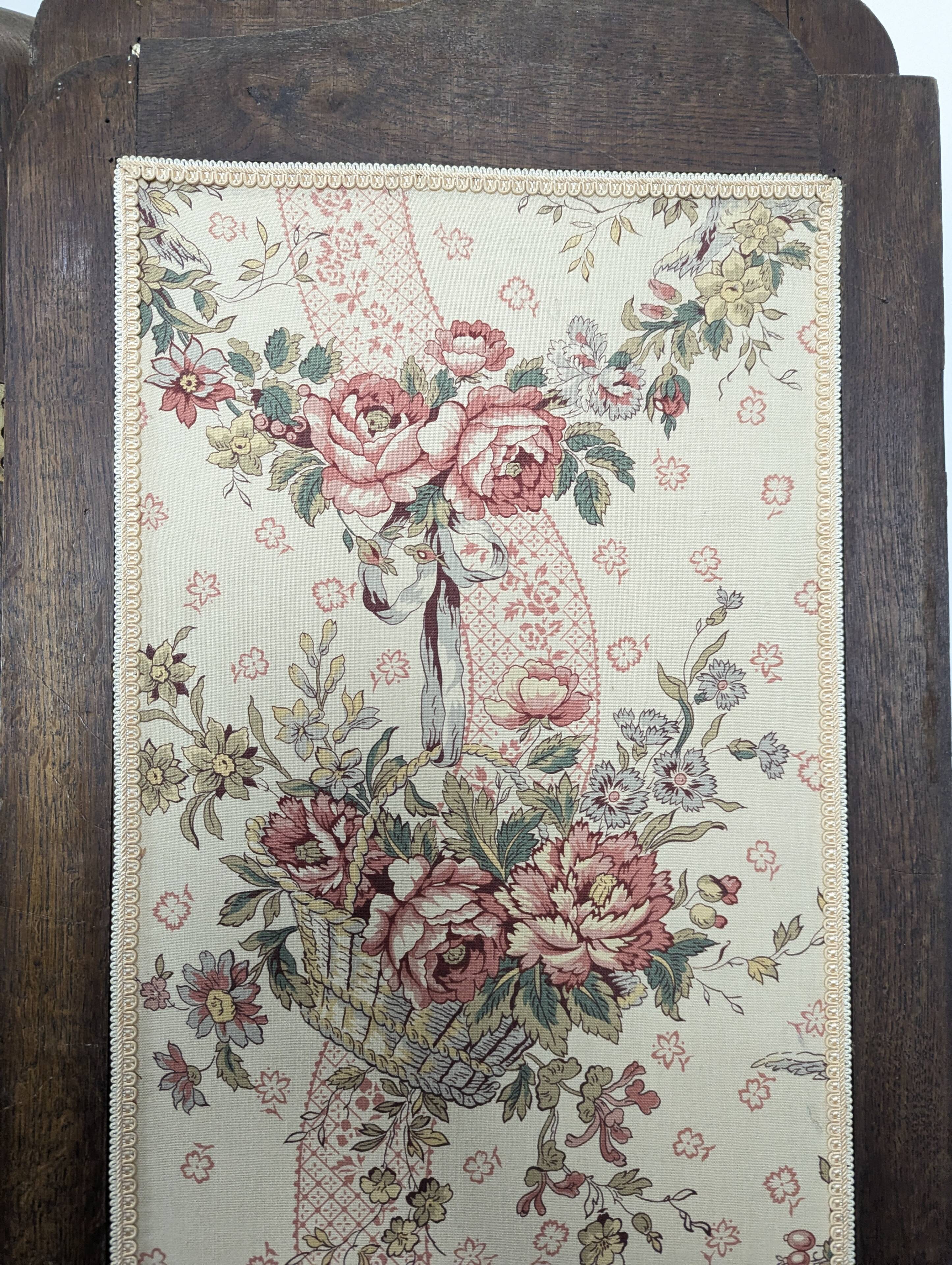 Four-panel oak screen adorned with floral upholstery from the 1930s.