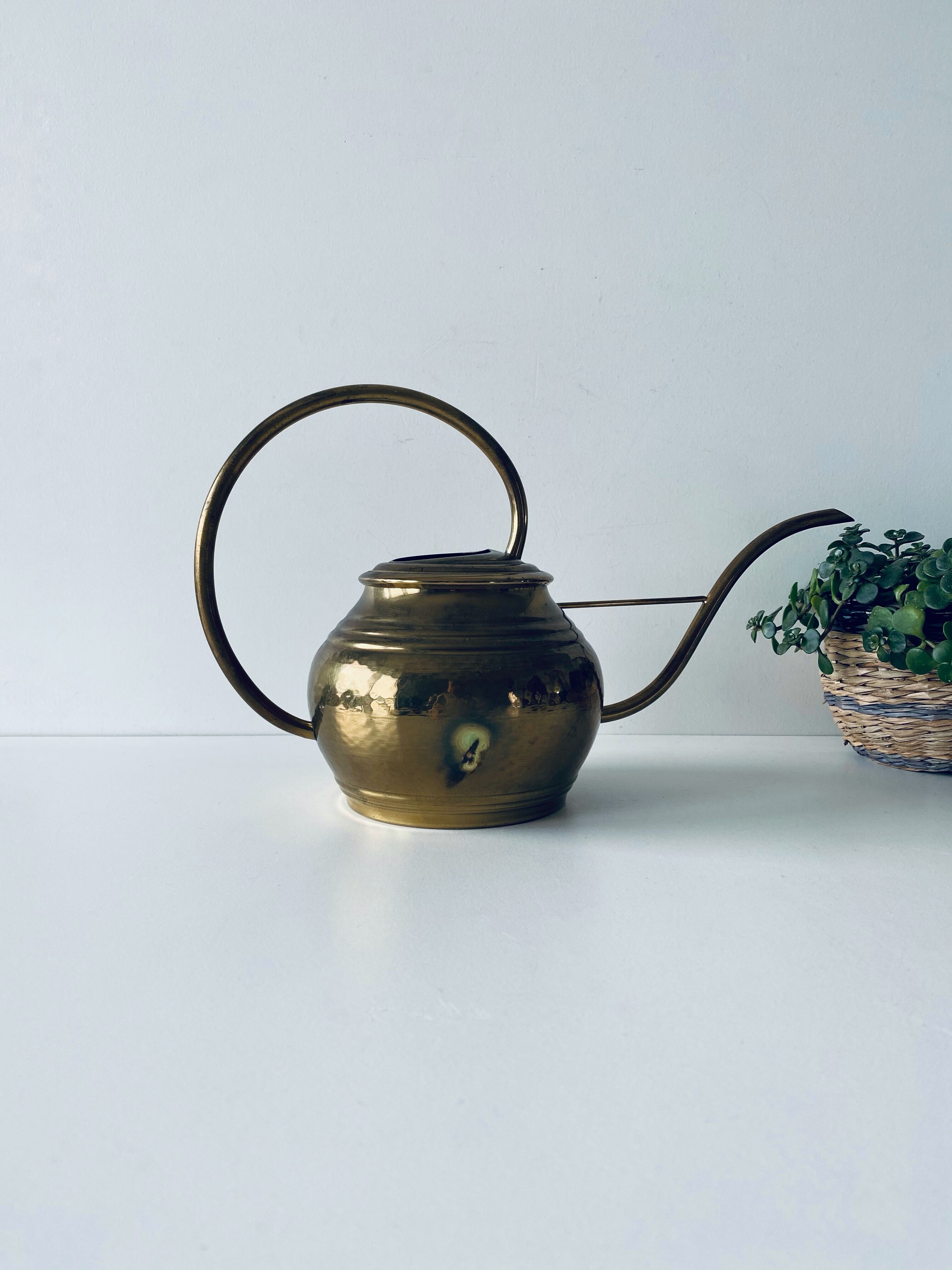 Old brass watering can