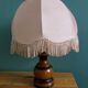 Turned wood bedside lamp with fabric lampshade