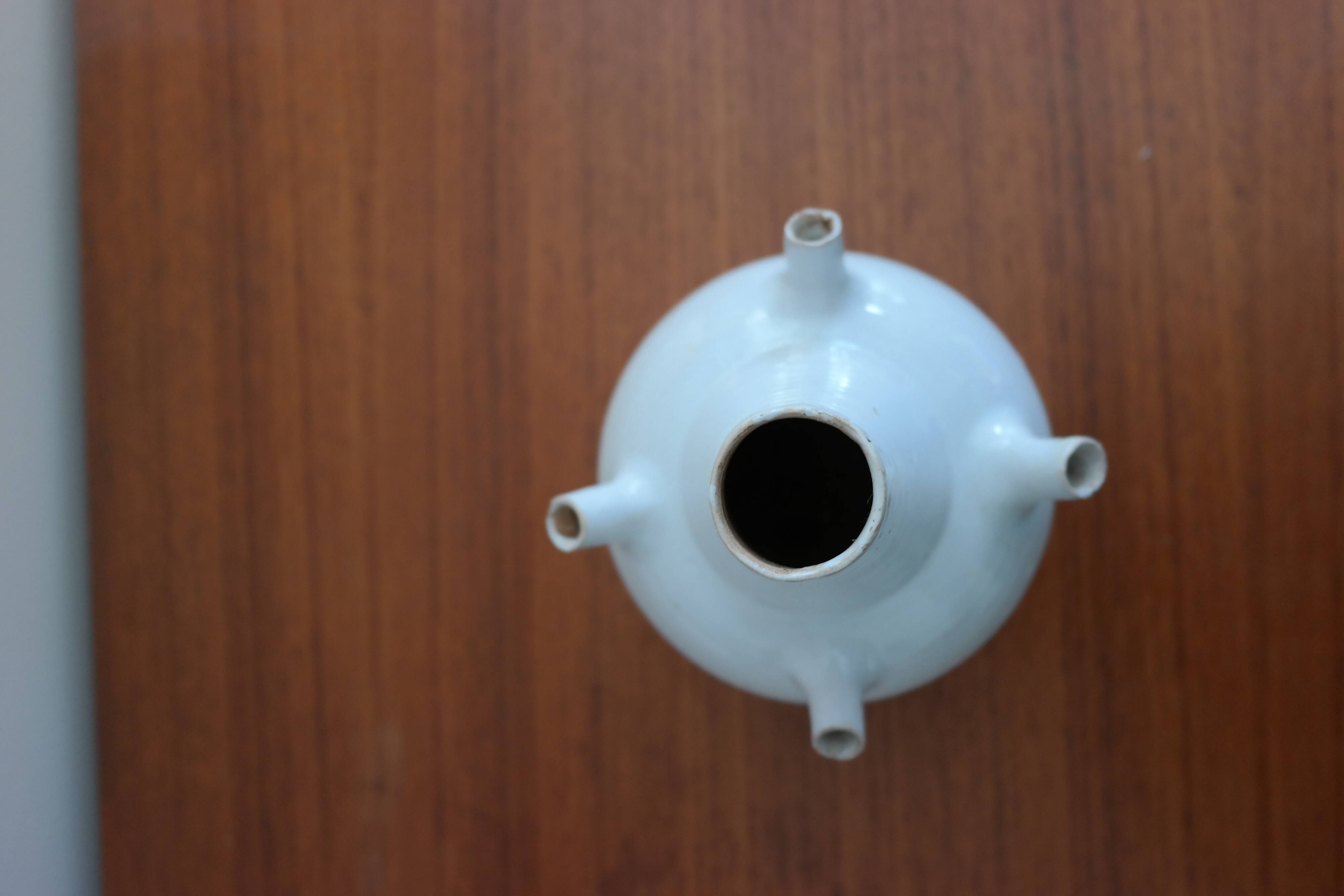 White enamelled earthenware flower vase signed HR