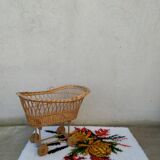 Rattan cradle for doll on vintage wheels