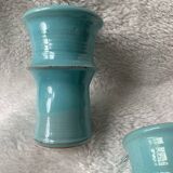 Two lovely turquoise ceramic mug vases.