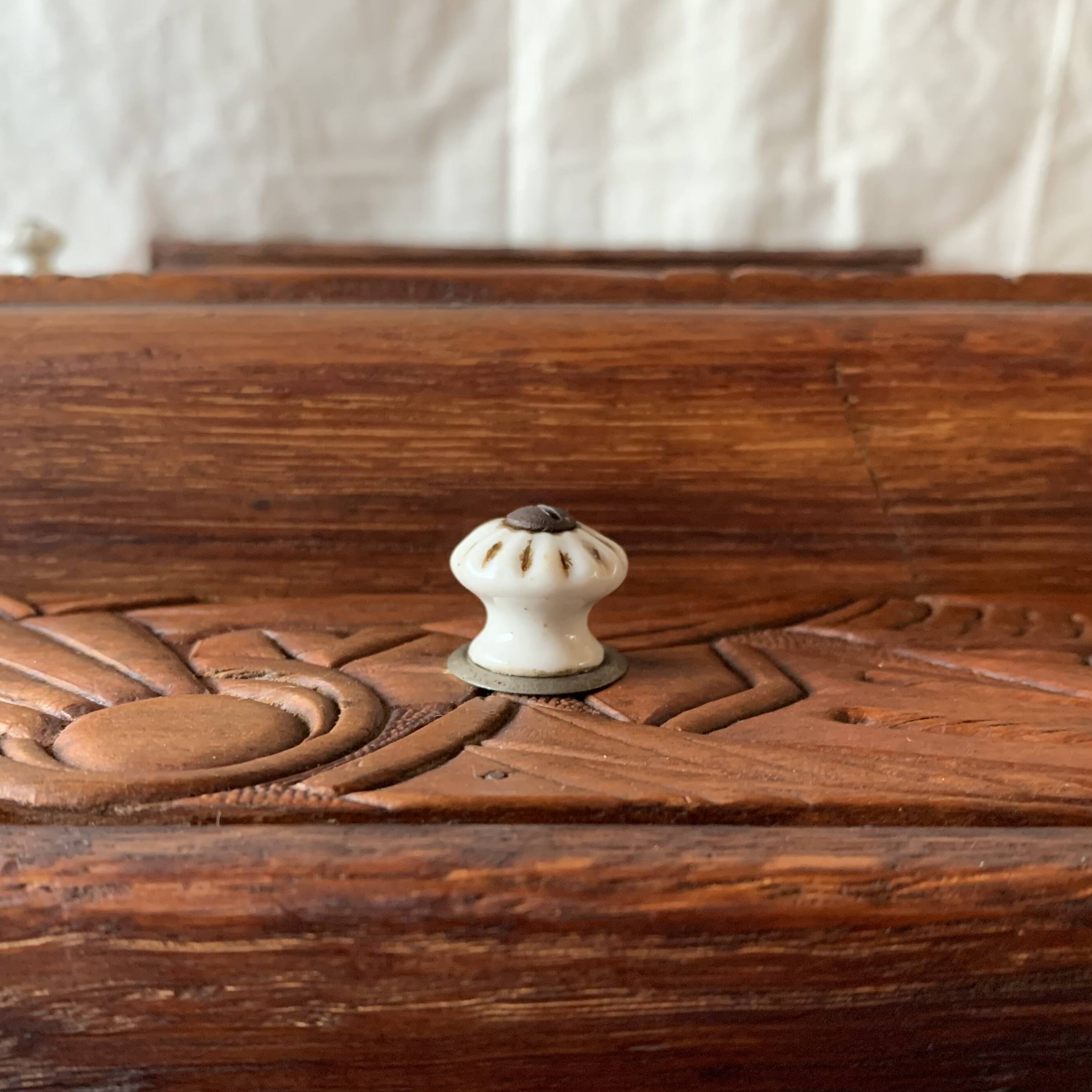Old carved wooden medicine cabinet with beveled mirror