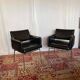 Pair of vintage armchairs in black faux leather and chrome metal.