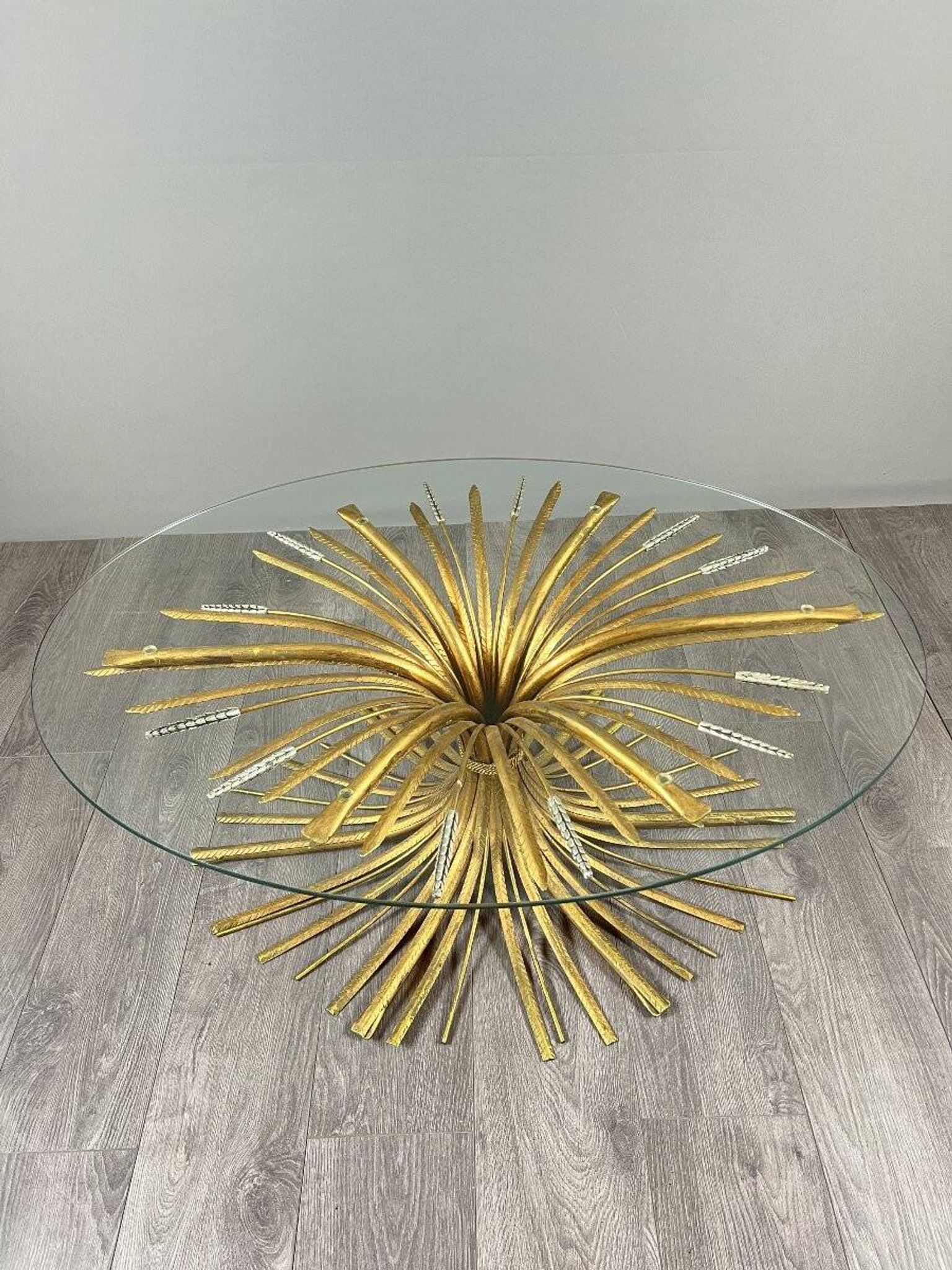 Gold metal and glass coffee table, 20th century, in the style of Robert Goos.