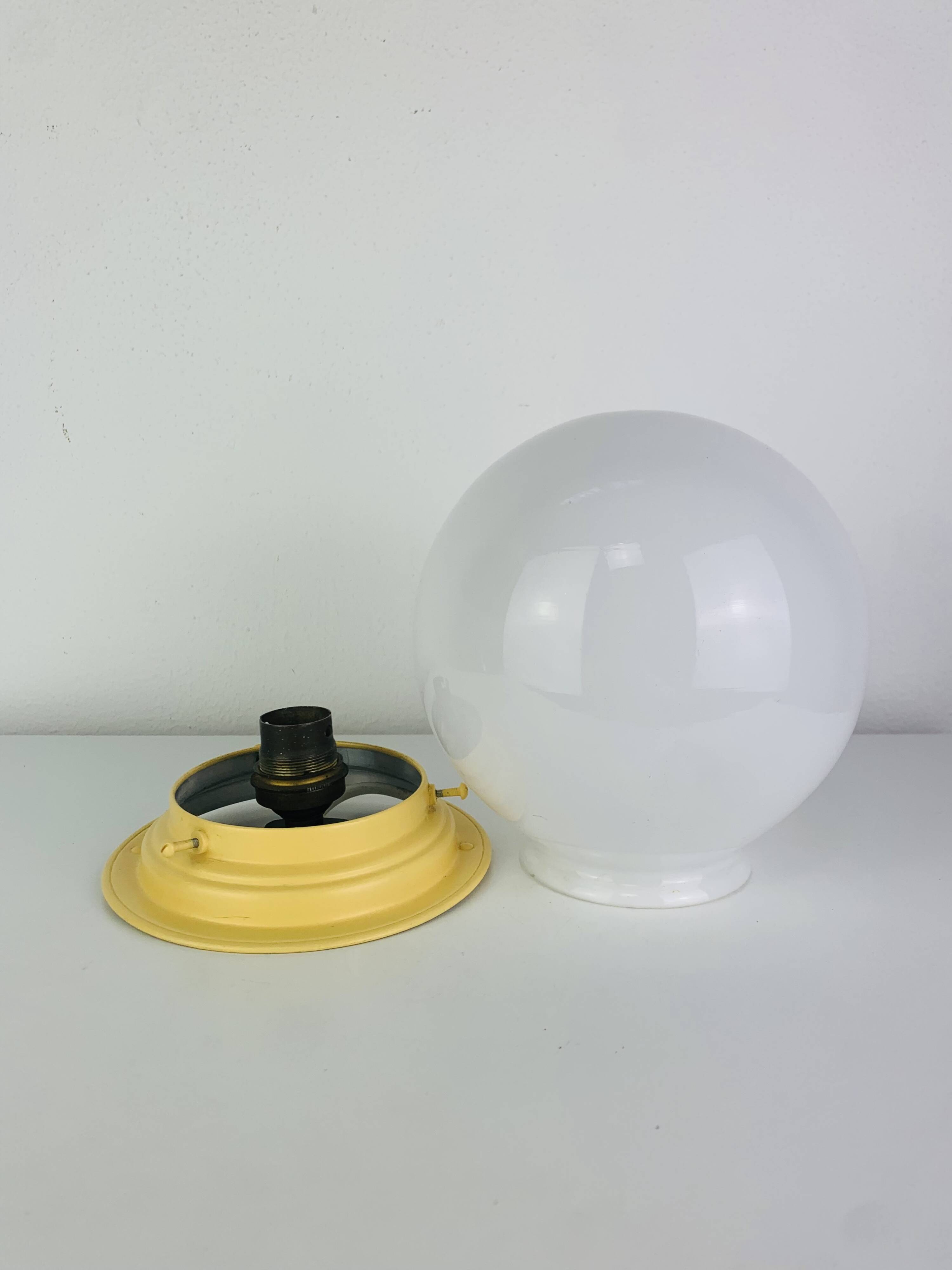 Art Deco opaline globe wall or ceiling light, yellow base