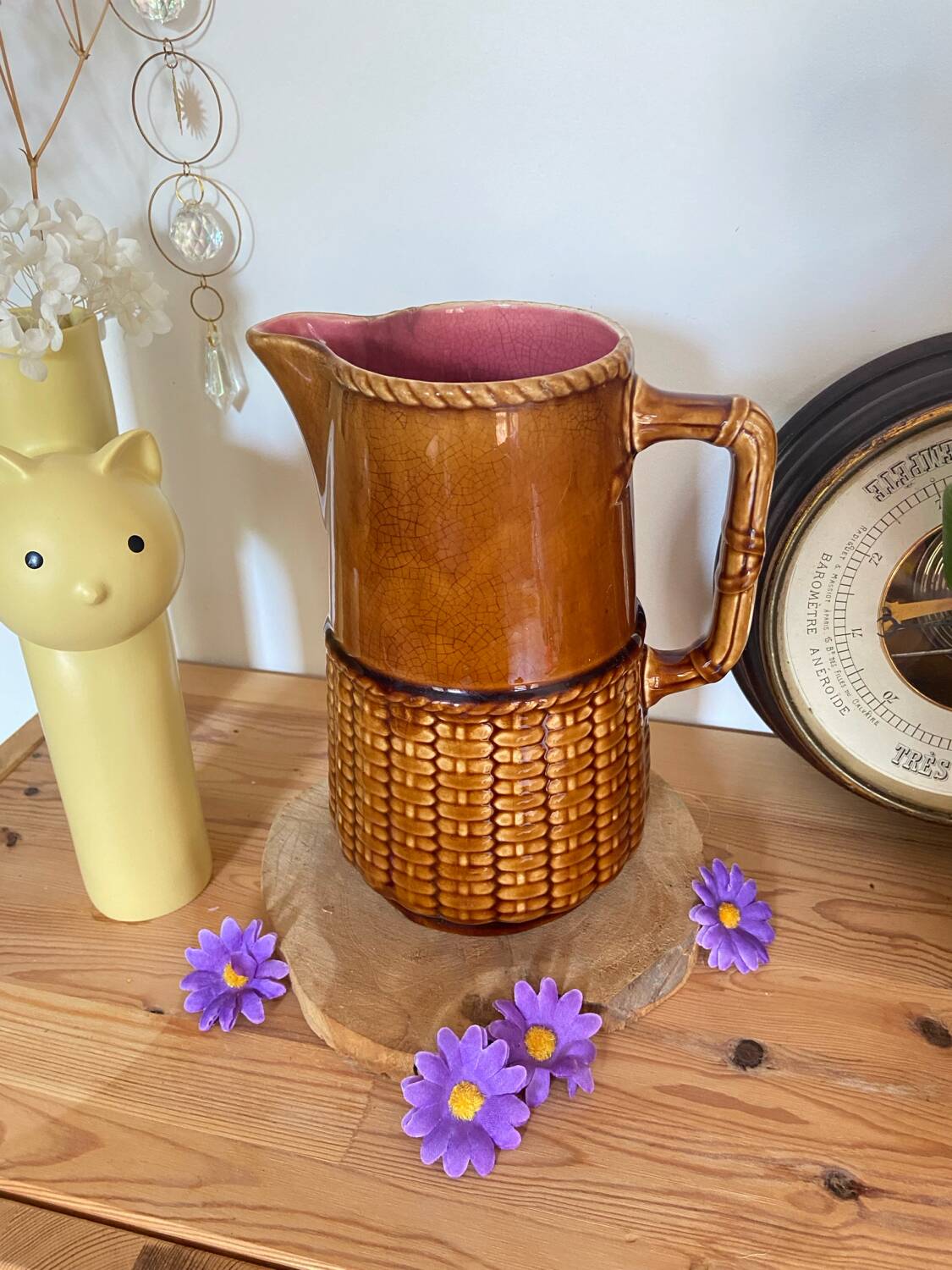 Antique vintage ceramic pitcher or jug from Sarreguemines, France. Brown with a pink interior, imitation basket.