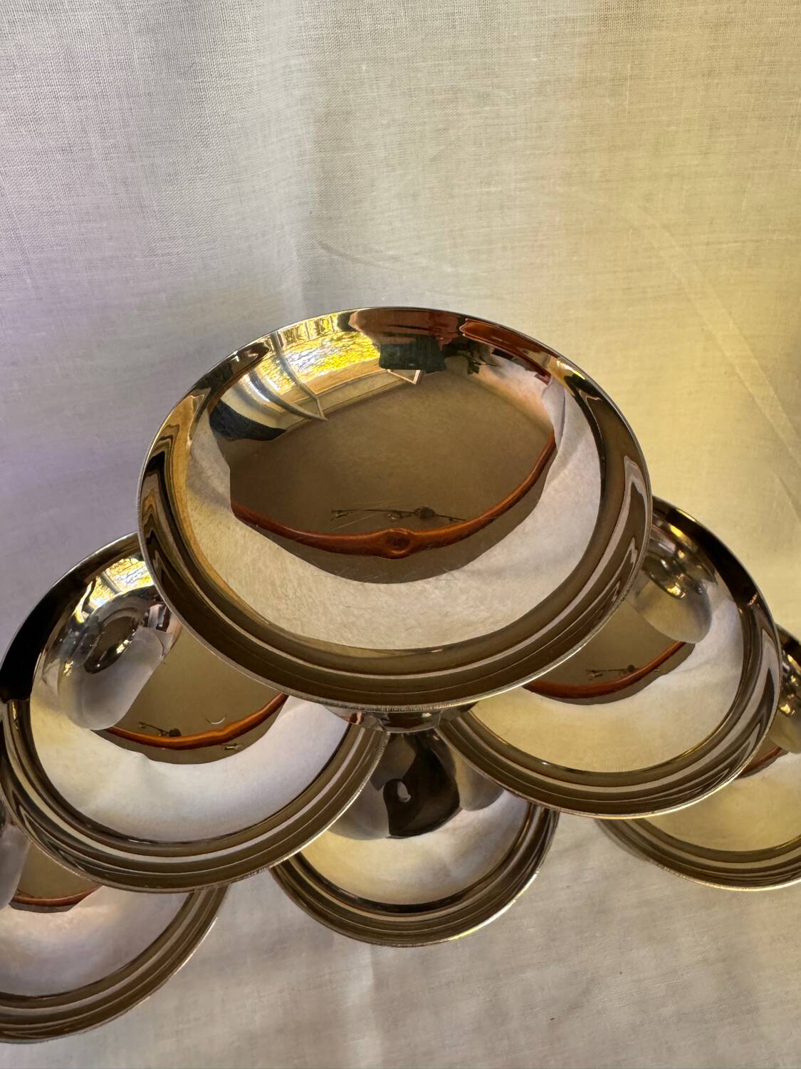 Set of 6 stainless steel ice cream bowls by Guy Degrenne with matching spoons.