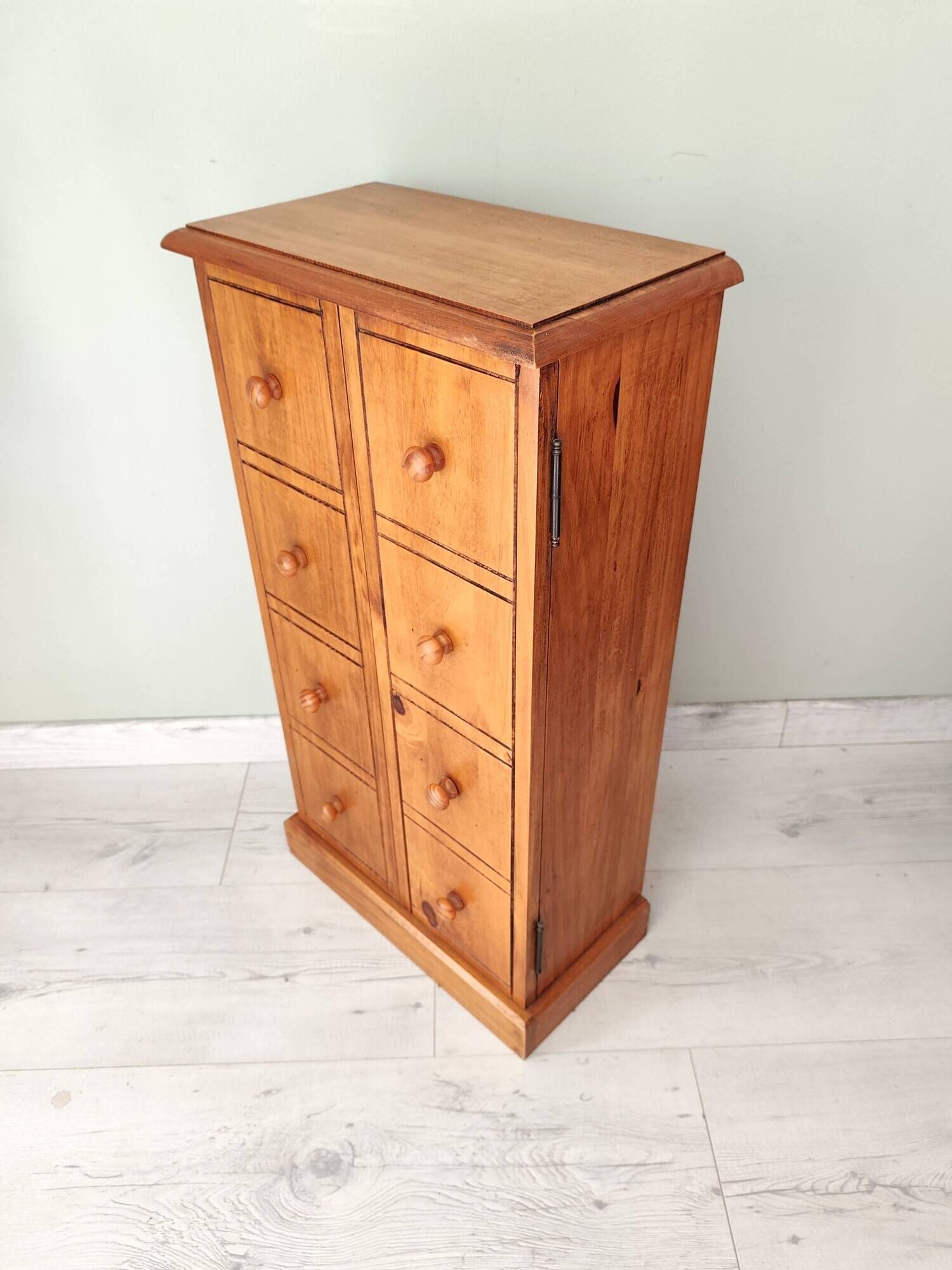 Small wooden piece of furniture, cabinet style, false drawers.