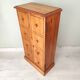Small wooden piece of furniture, cabinet style, false drawers.