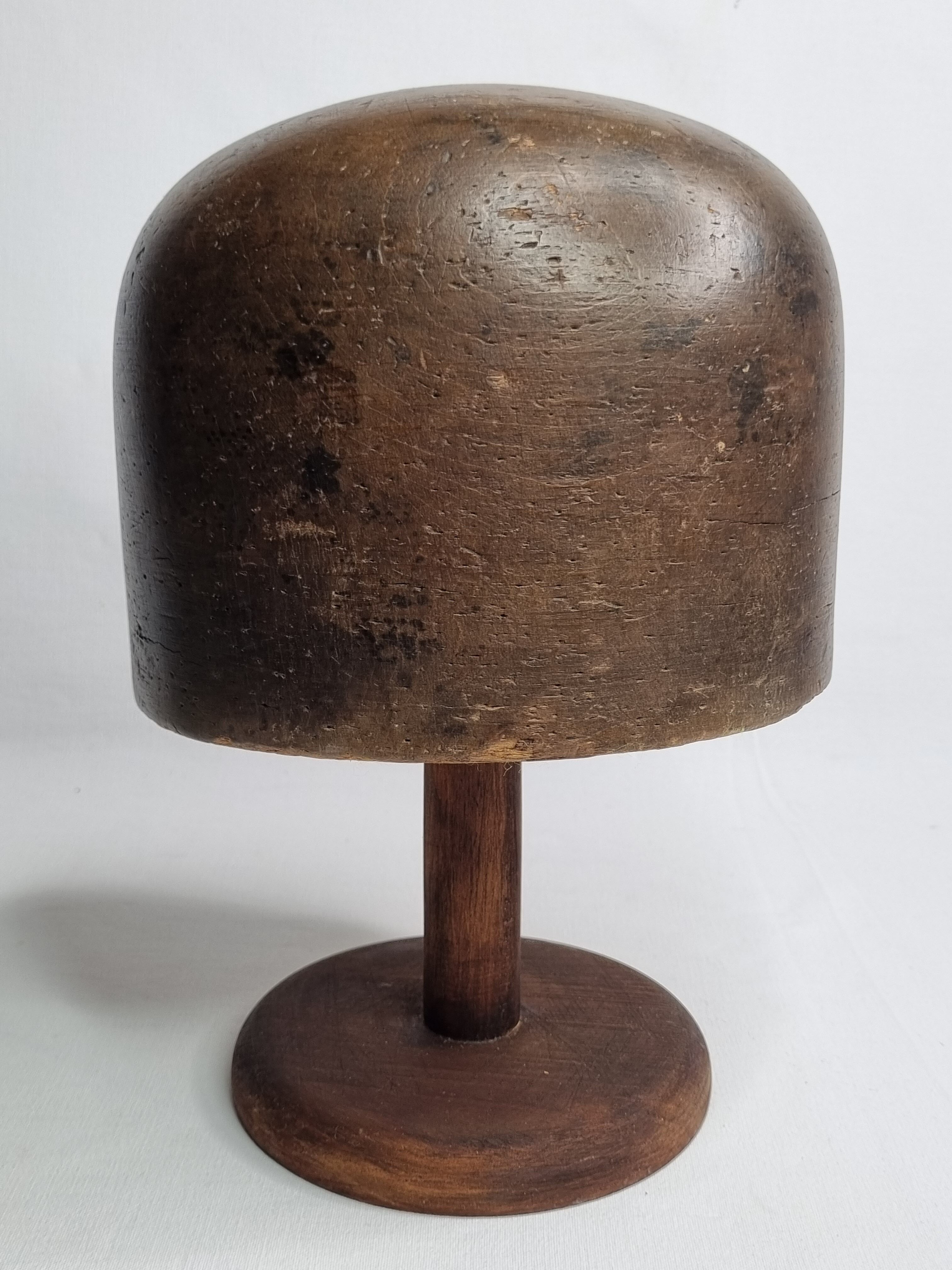 Old solid wood hat shape on foot, 1900
