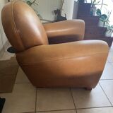Brown leather club armchairs with an antique finish.
