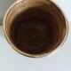 Rattan and brass pot cover
