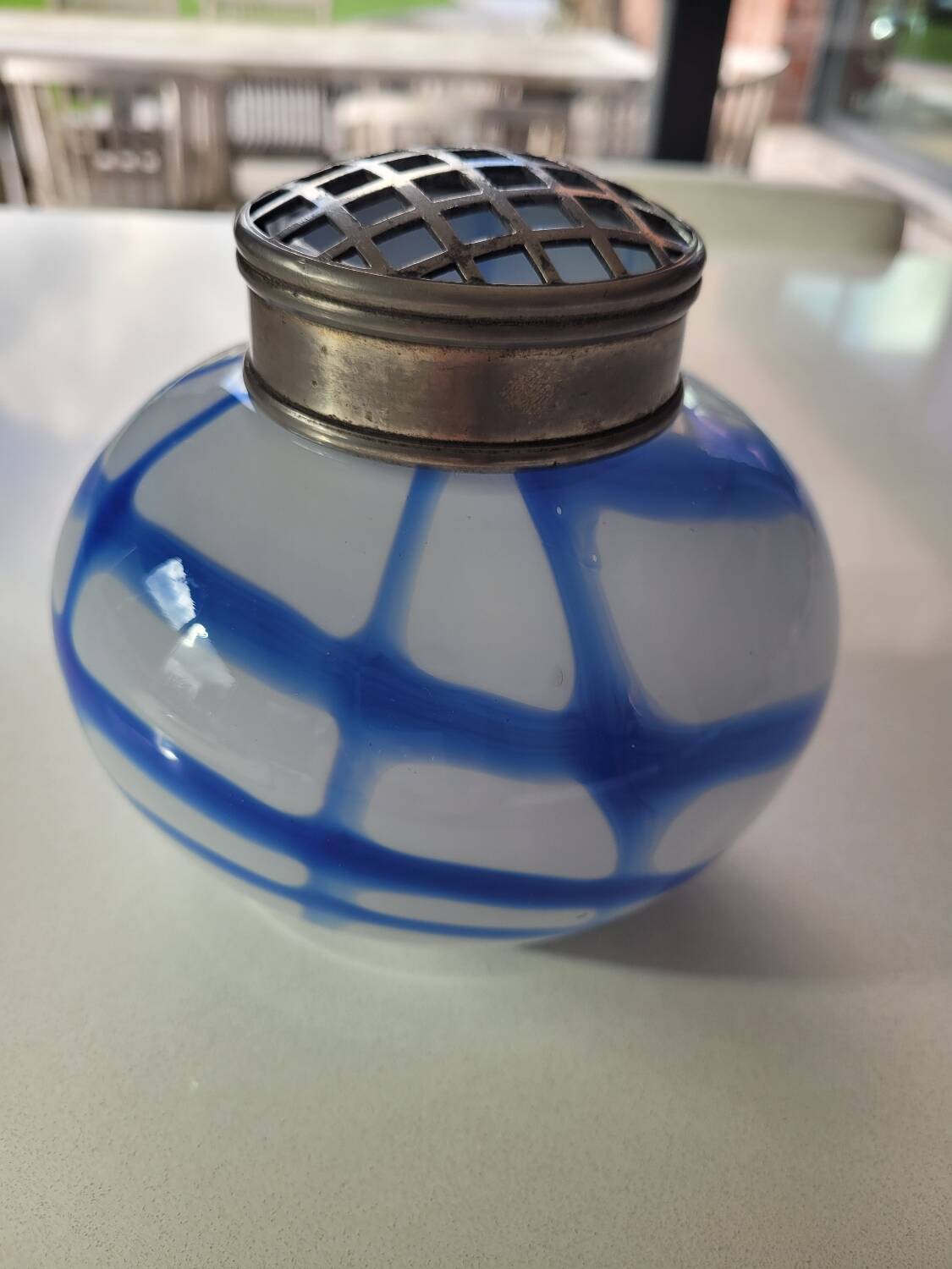 Old white and blue glass flower vase