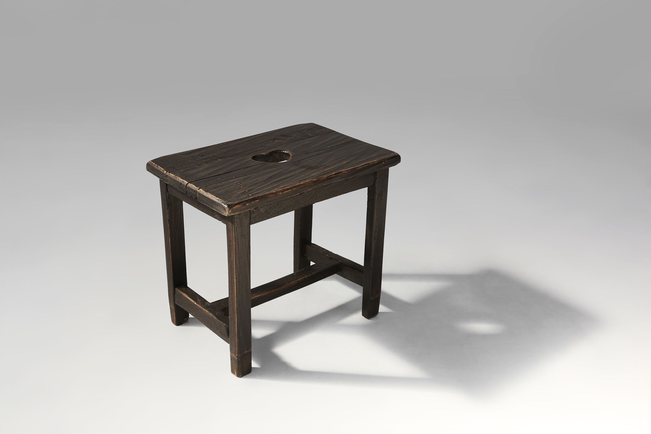 Rustic black wooden stool, Ca.1920