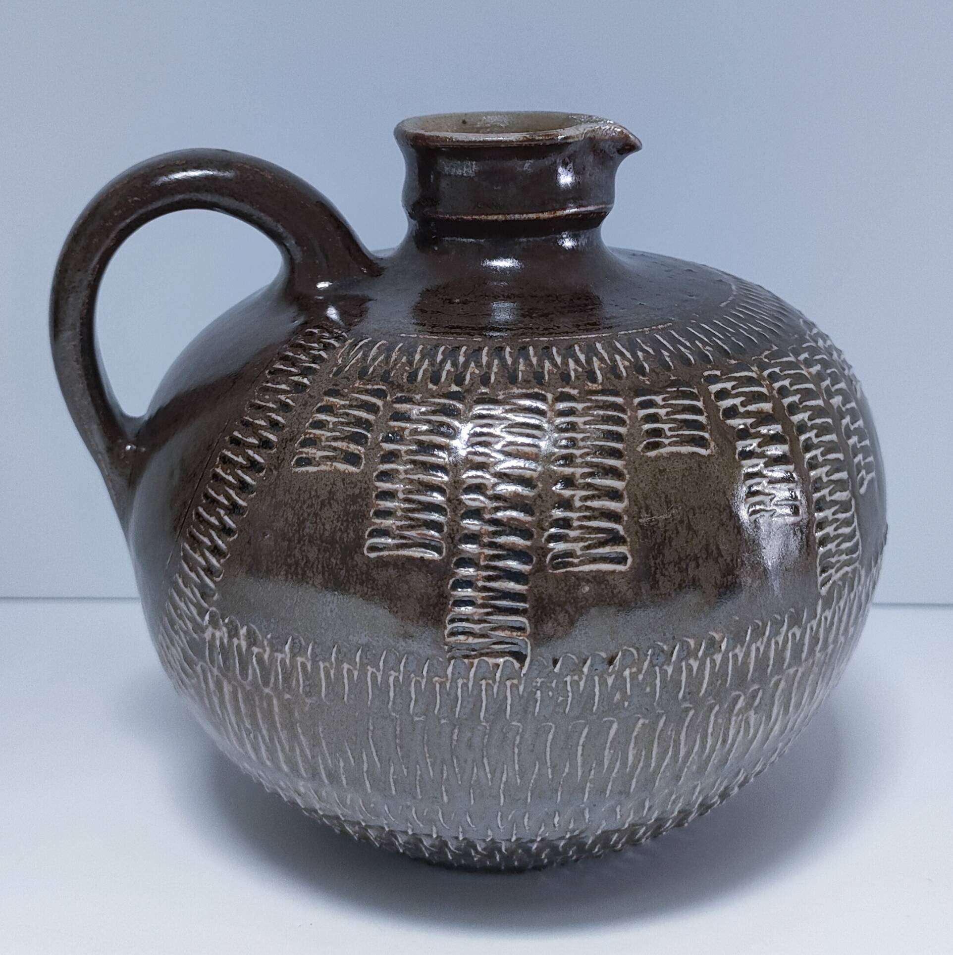 Vintage scarified glazed stoneware pitcher