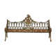 Sculpted cast iron bench with green patina