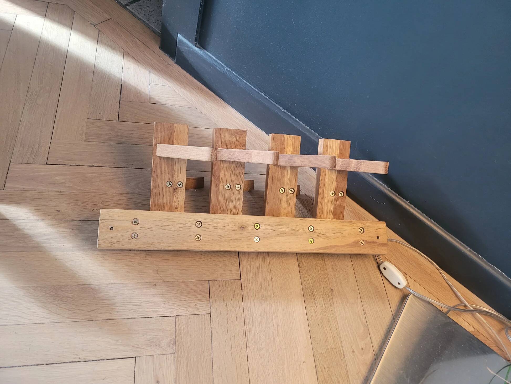 Articulated vertical wall coat rack