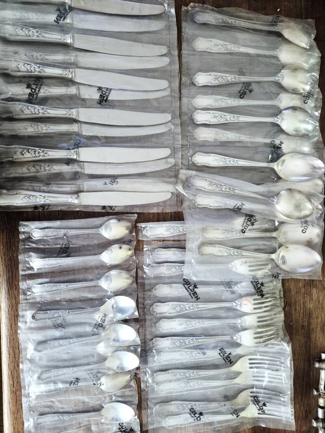 48 new silver-plated metal cutlery pieces in blister packaging.
