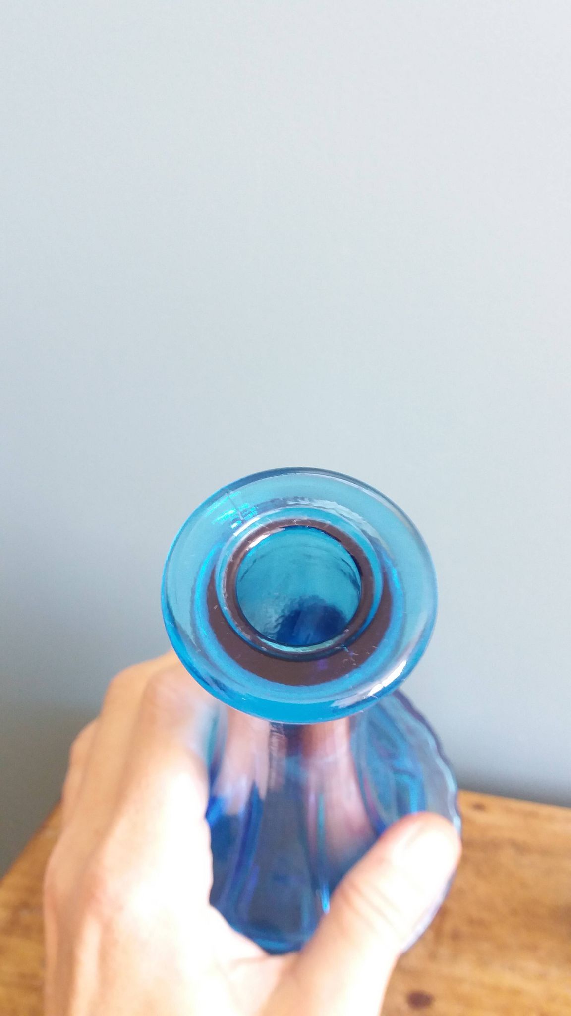 Turquoise glass carafe bottle with a stopper.