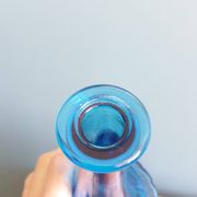 Turquoise glass carafe bottle with a stopper.