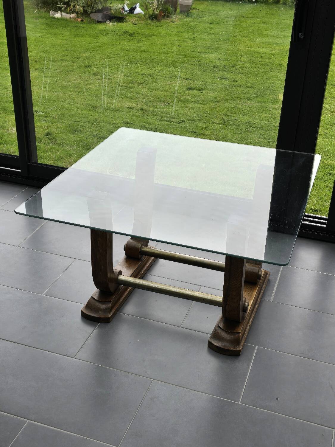Art Deco coffee table in glass, wood, and brass.