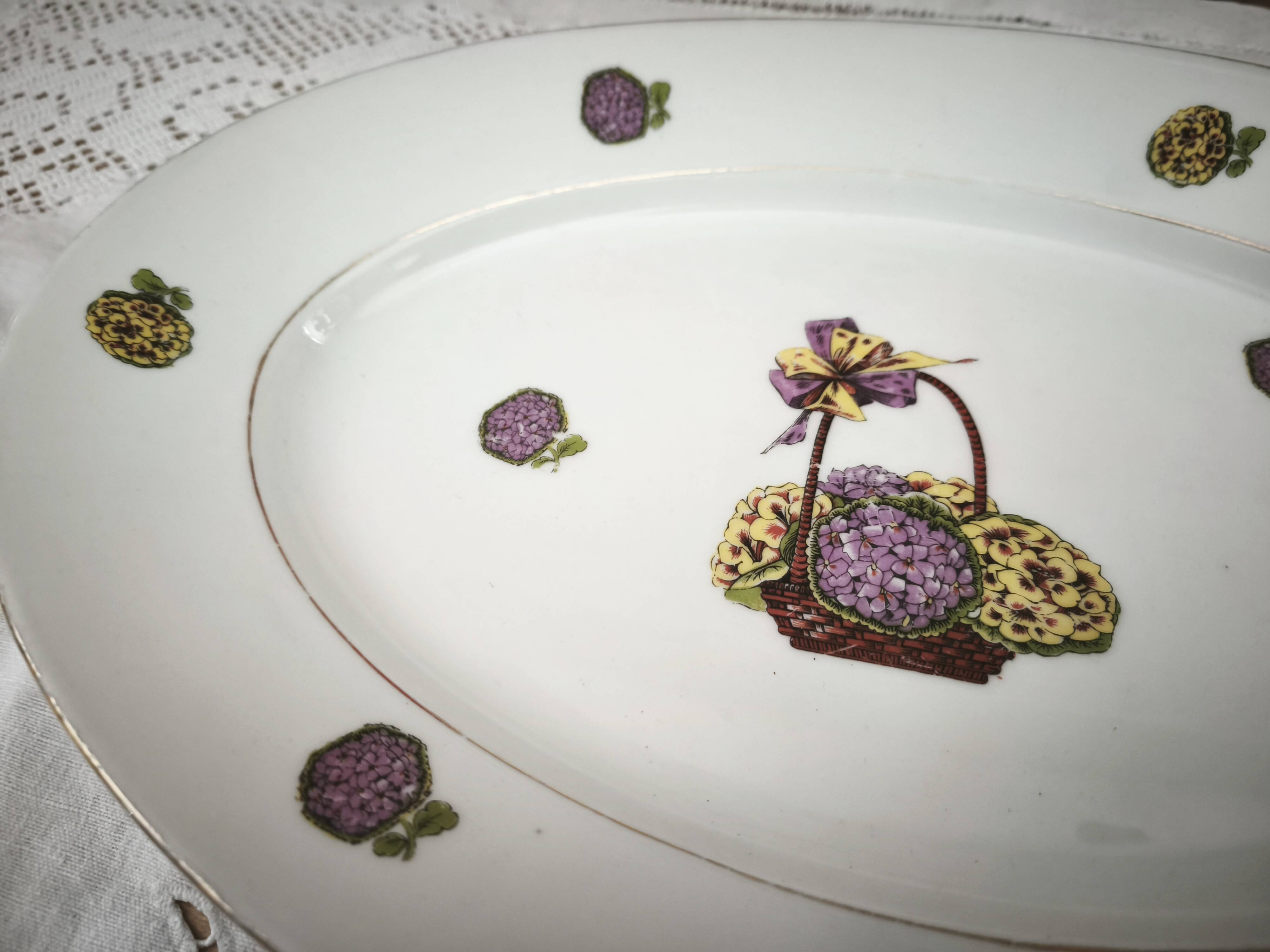 Oval porcelain plate from Limoges with a hydrangea basket design.