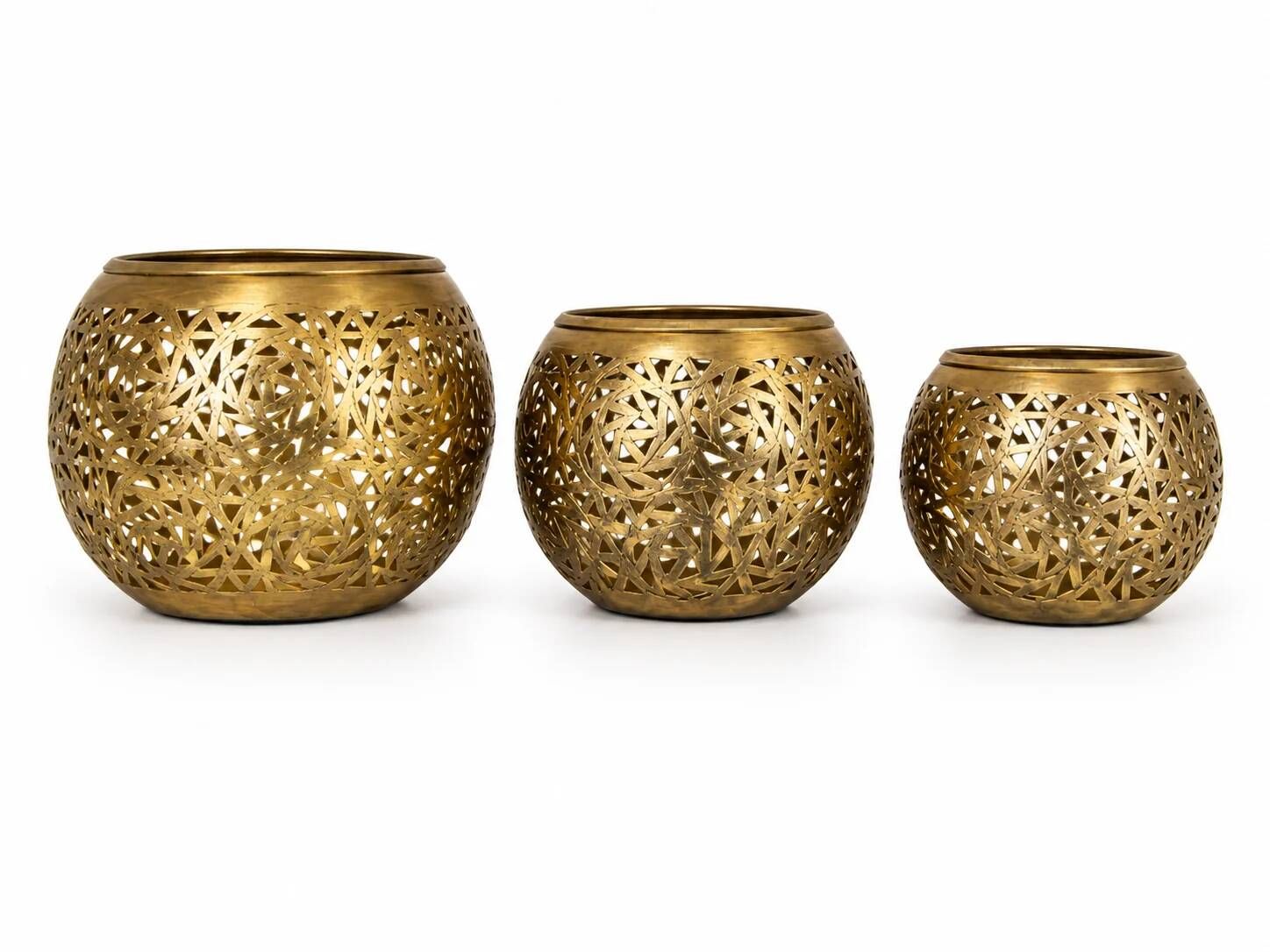 Set of 3 handmade brass candle holders with an openwork pattern.
