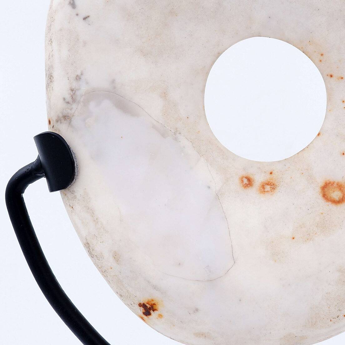 "Wamayuwa" Boiken coin in hand-carved shell mounted on a black metal stand