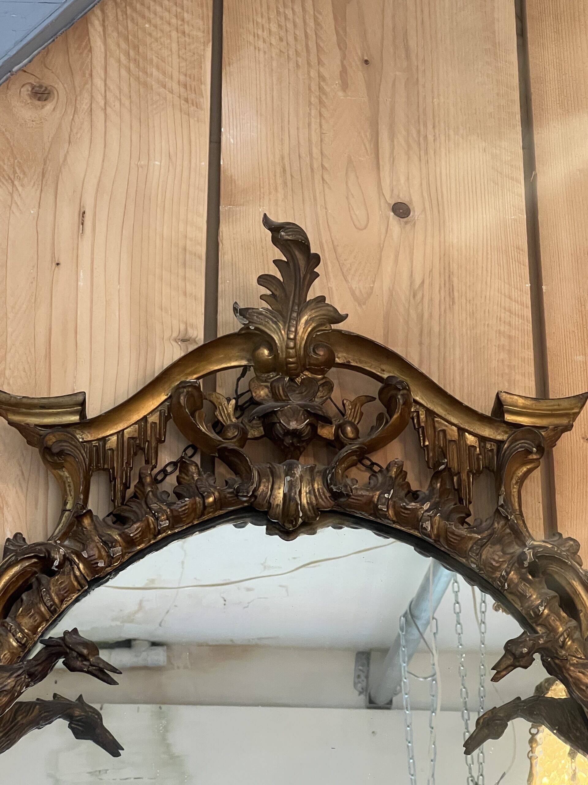 Large gilded wooden mirror, richly carved with winged dragons, 19th century