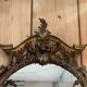 Large gilded wooden mirror, richly carved with winged dragons, 19th century