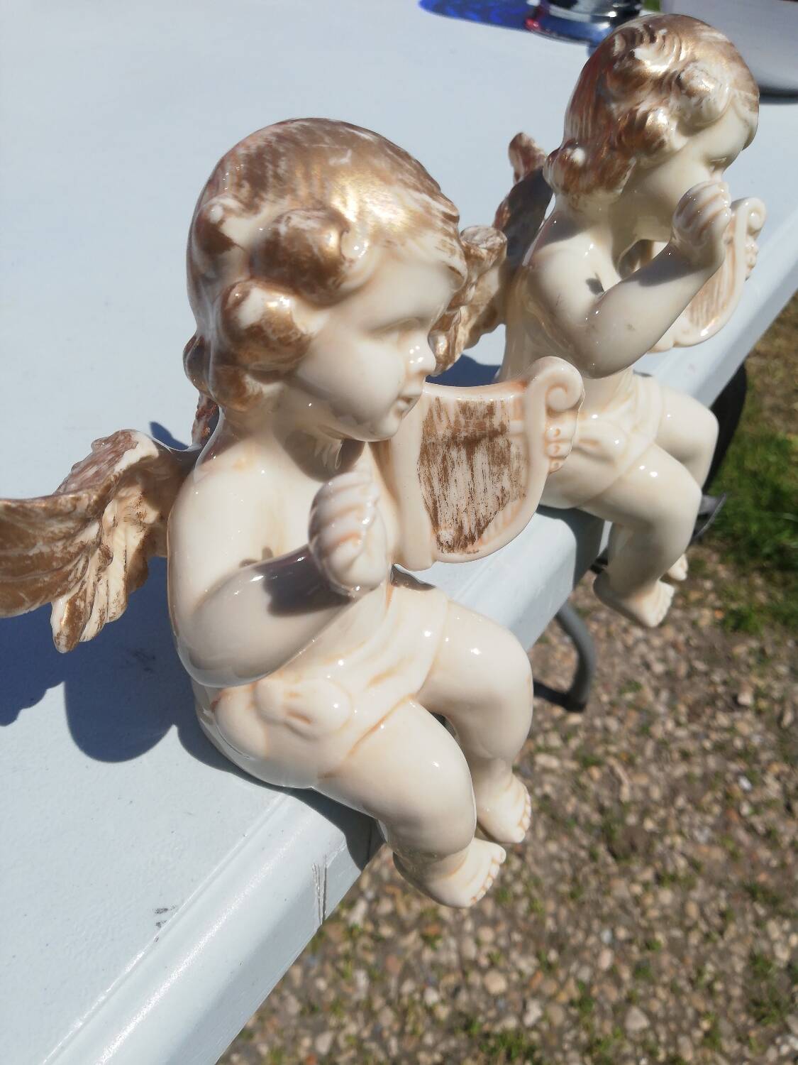 Pair of sitting angel statuettes