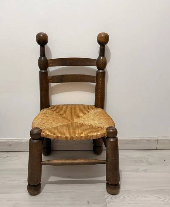 Low fireplace chair in the style of Charles Dudouyt – wood and straw seat.