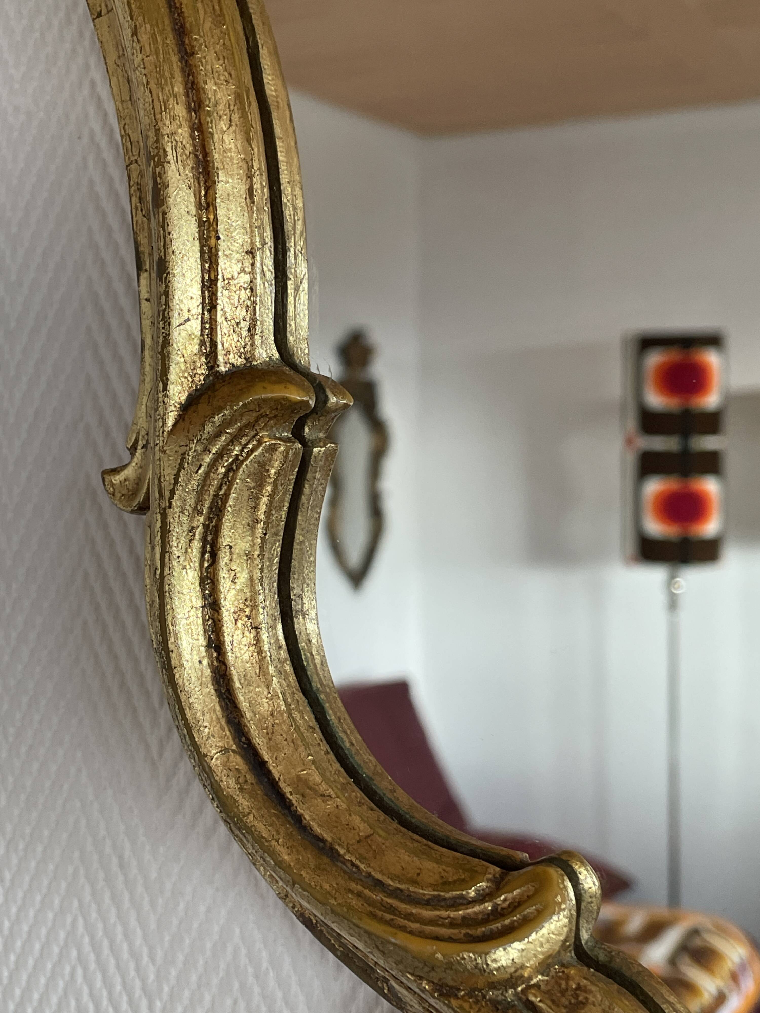 Old baroque style wall mirror with golden moldings